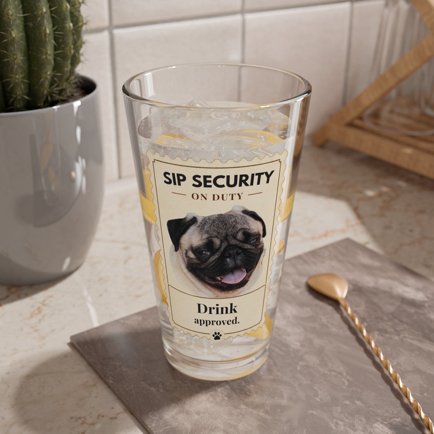 Sip Security custom pet glass filled with ice on a kitchen counter beside a cactus