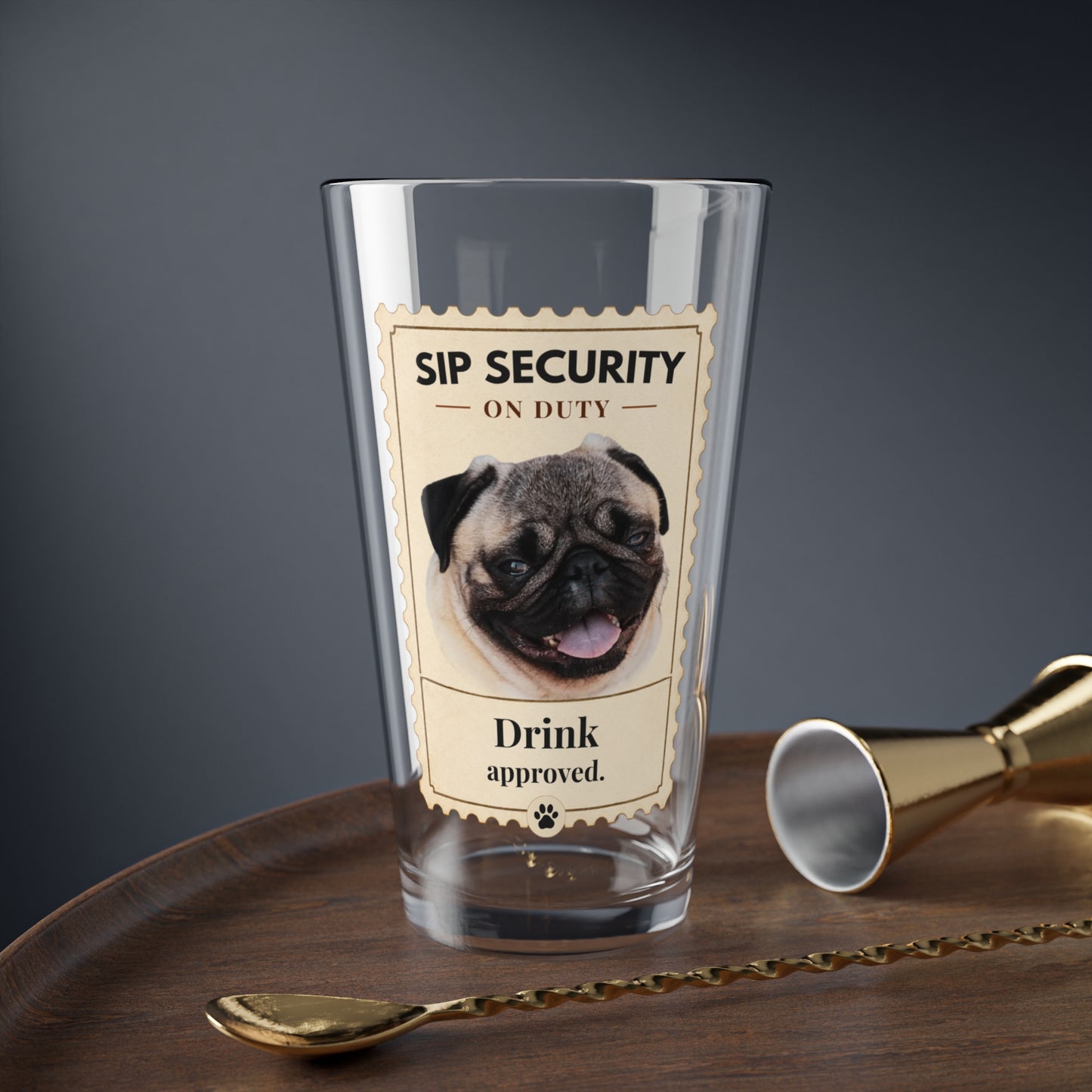 Custom pet mixing glass with Sip Security pug design on a bar tray with jigger and spoon