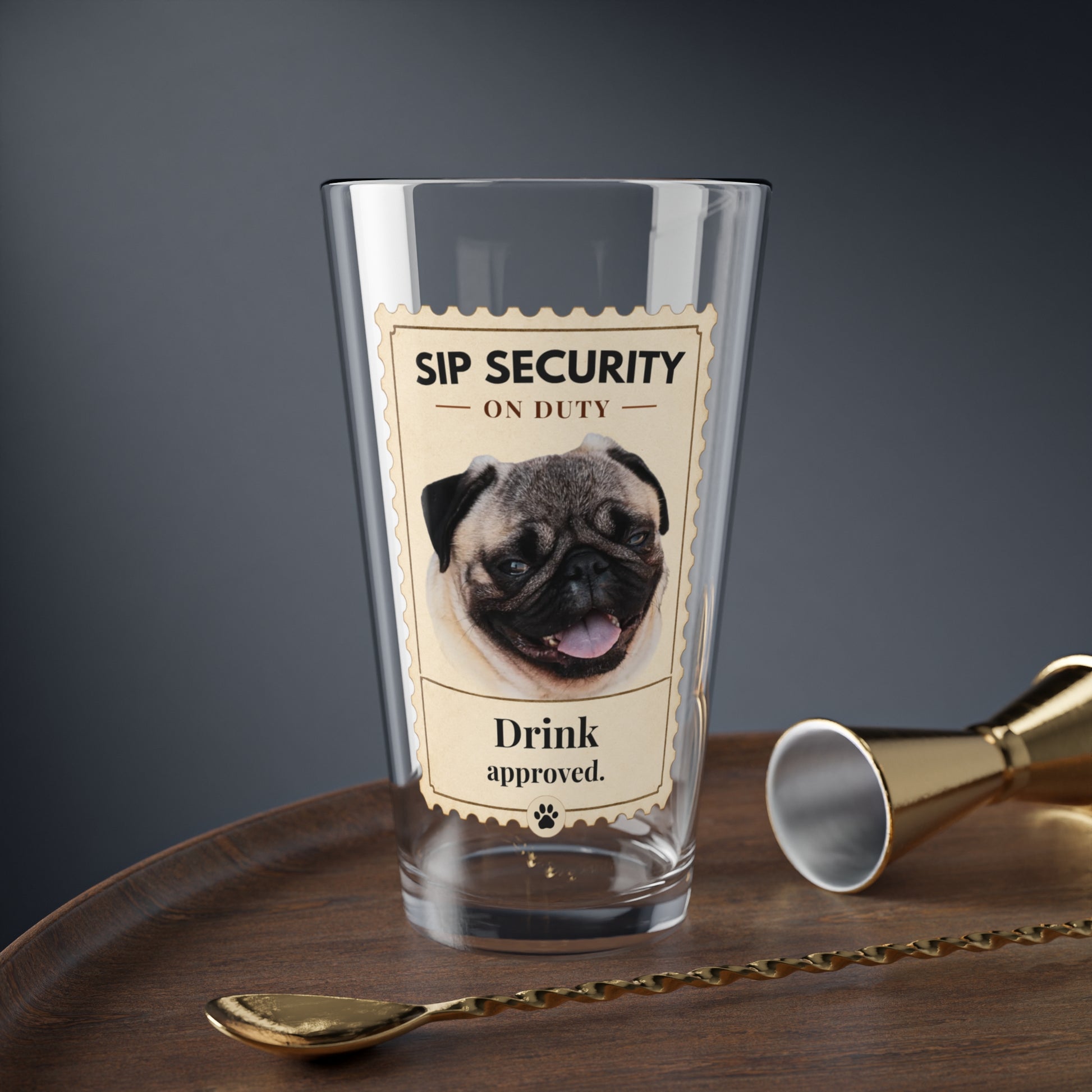 Custom pet mixing glass with Sip Security pug design on a bar tray with jigger and spoon