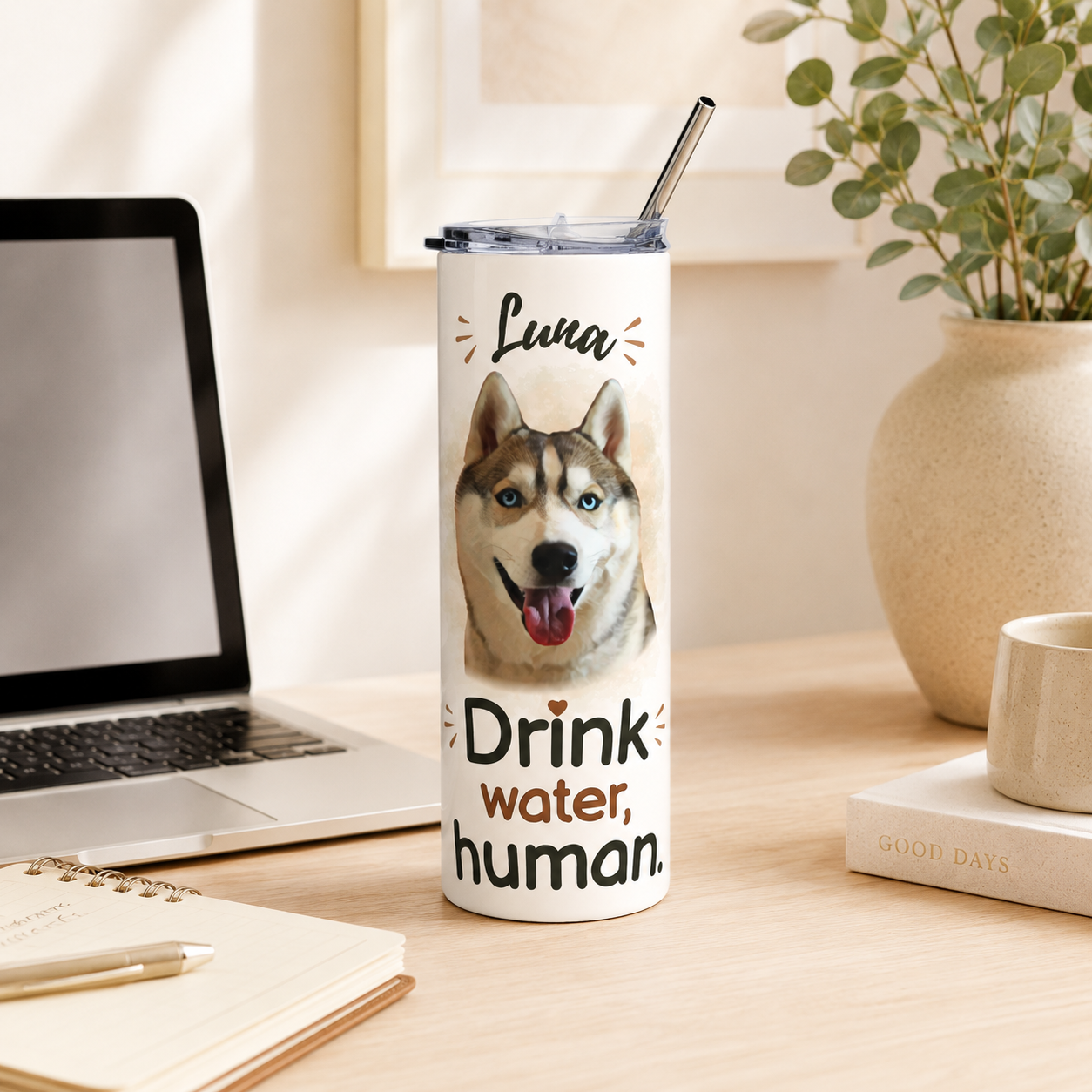 Husky-print dog mom tumbler on a desk beside a laptop, plant, and notebook.