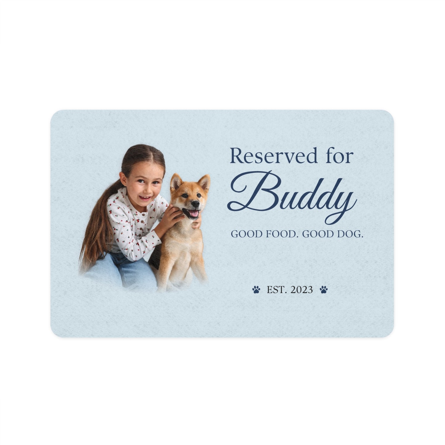 Blue dog placemat printed with a photo of a girl hugging her Shiba Inu and the name Buddy, est. 2023.
