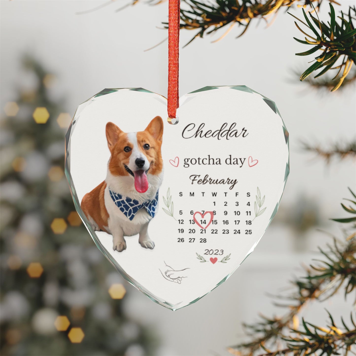Close-up of the personalized dog ornament with Christmas tree lights blurred behind it.