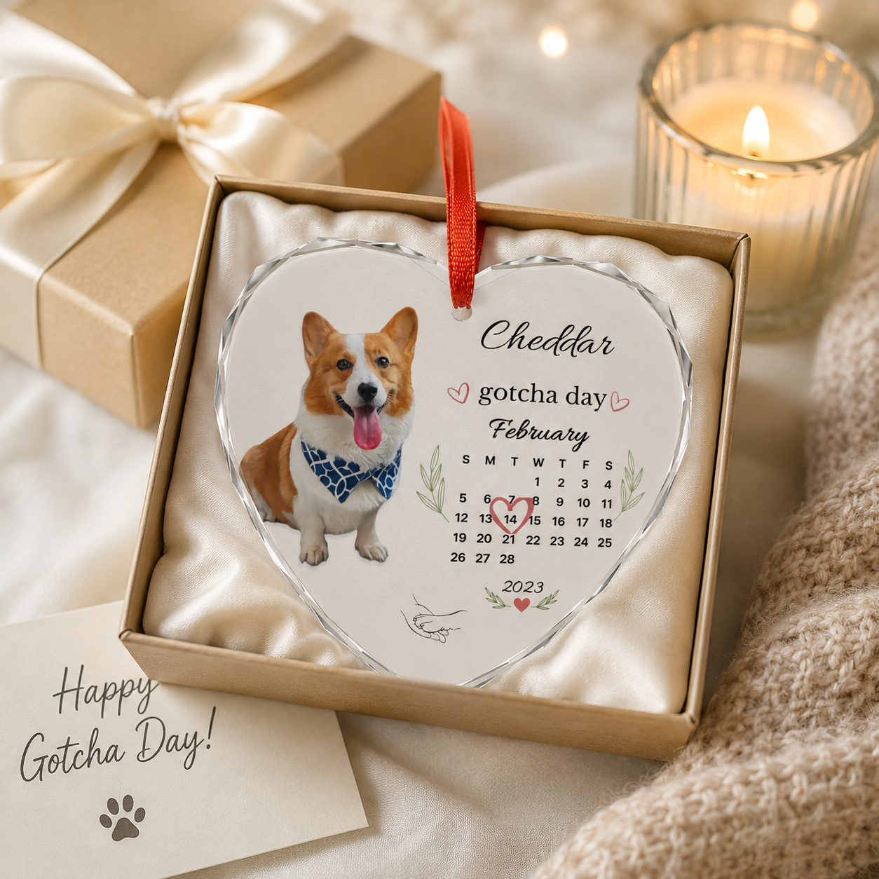 Personalized gotcha day dog ornament displayed in a kraft gift box beside a candle and greeting card.