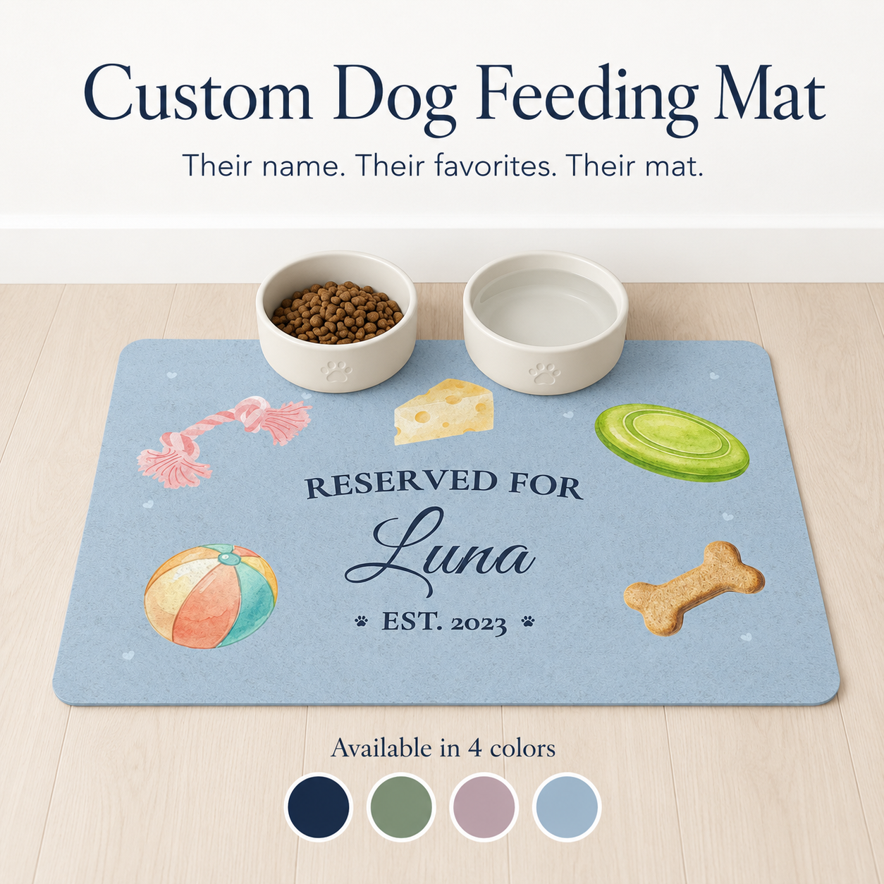 Light blue custom dog bowl mat personalized with the name Luna and rope toy, frisbee, ball icons.