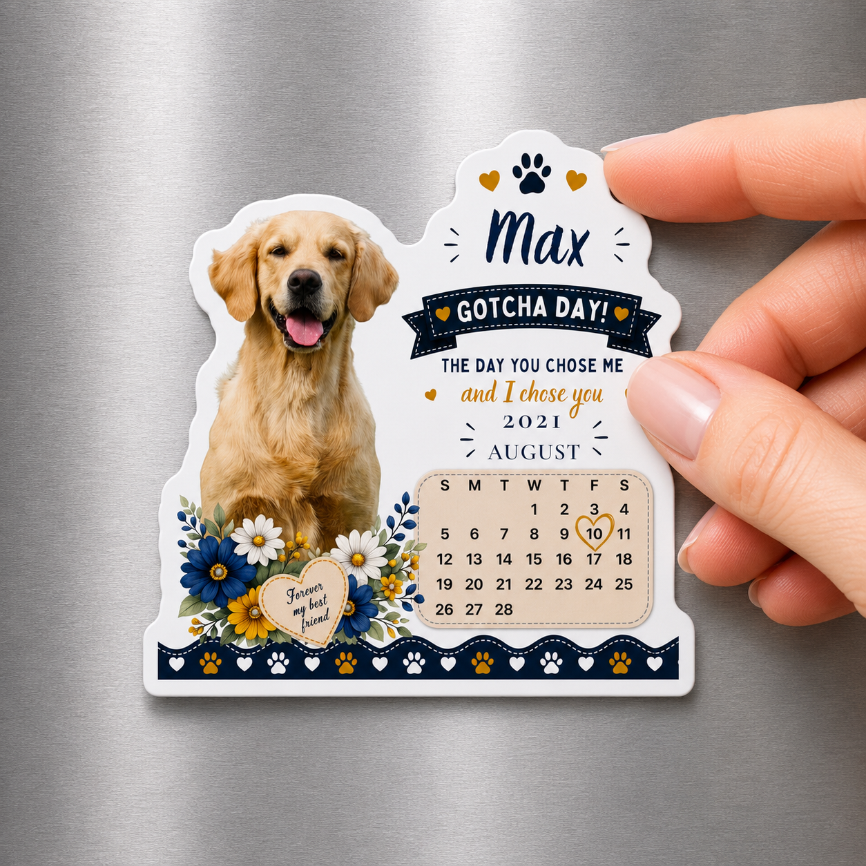 Personalized Gotcha Day magnet for a golden retriever held up against a stainless steel fridge.